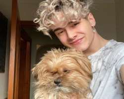 Joshua loves to play with his dog at the time he is getting bored in his home.